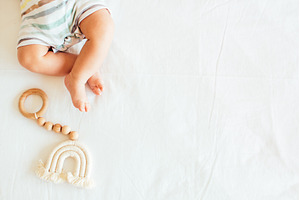 Baby playing with a wooden toy on