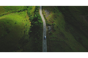 Car driving on winding road in Sumba, a Nature Photo by Goinyk