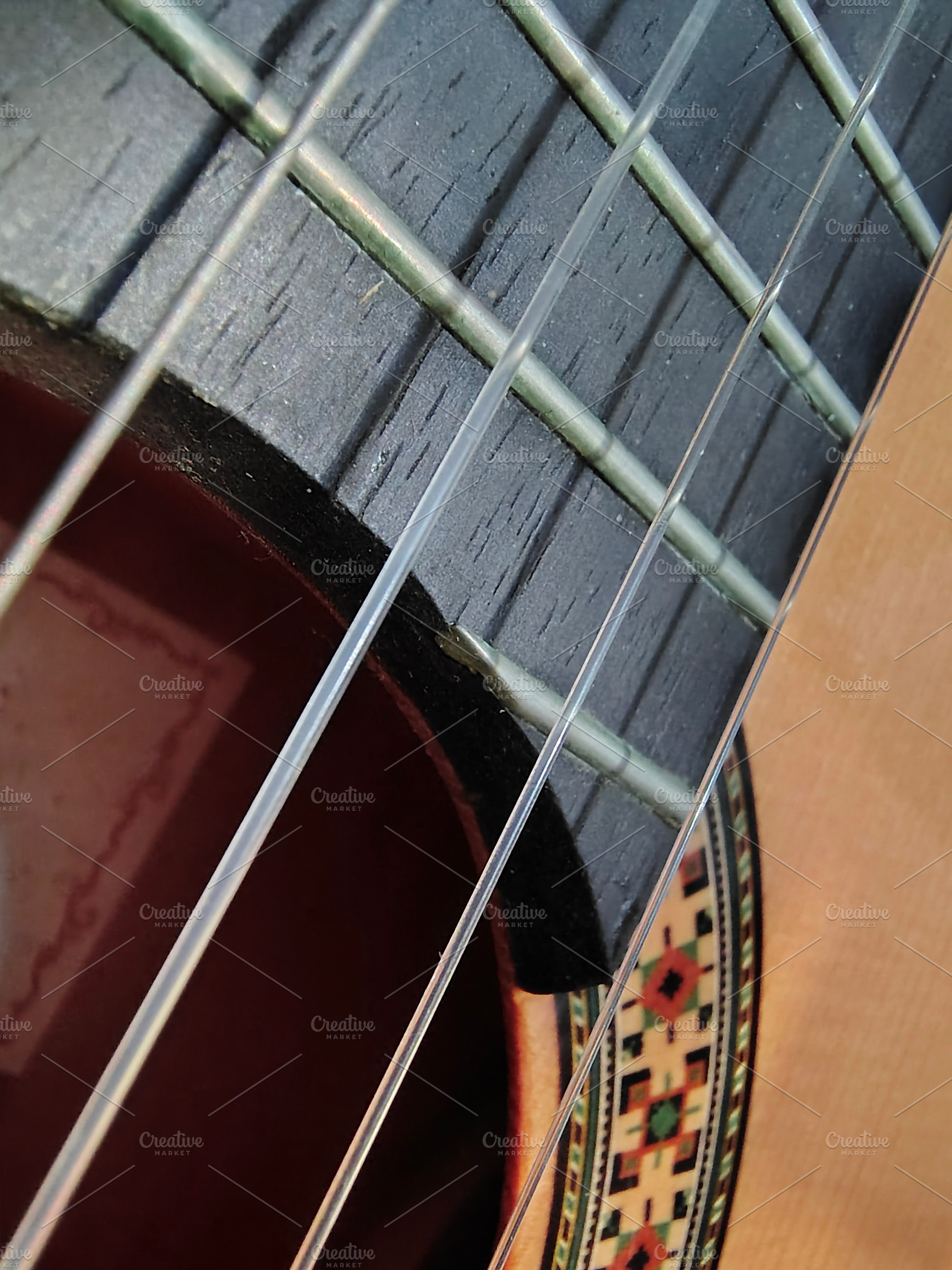 Close-up, high-angle detail shot of a classic spanish guitar, an Arts & Entertainment Photo by DanFLCreativo