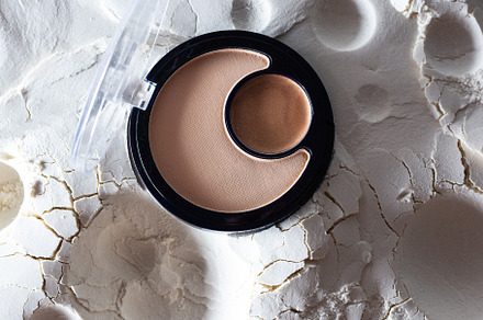 Cosmetics on abstract lunar surface, a Beauty & Fashion Photo by Pandateam