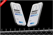 Two Smartphones Chain Link Fence PSD, an Advertising Mockup by Bruno's Shop (Thumbnail 1 of 3)