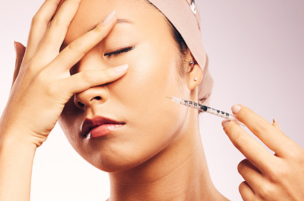 Woman, plastic surgery and portrait with filler in studio background with bandage for skincare. Female person, injection and face with collagen and cosmetic treatment for beauty and wellness., a Photo by Peopleimages.com