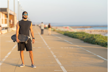 A man standing on the road holding a, a Sports & Recreation Photo by Barcelona_dreams