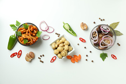 Bowls of marinated mushrooms on white background, a Food & Drink Photo by AtlasStudio PRO