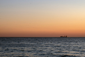 Sea at sunset and silhouette of ship, a Nature Photo by Schreibikus