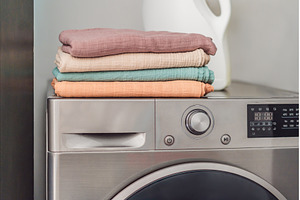 Stack of soft muslin baby swaddles, a Background Photo by Elizaveta Galitskaya