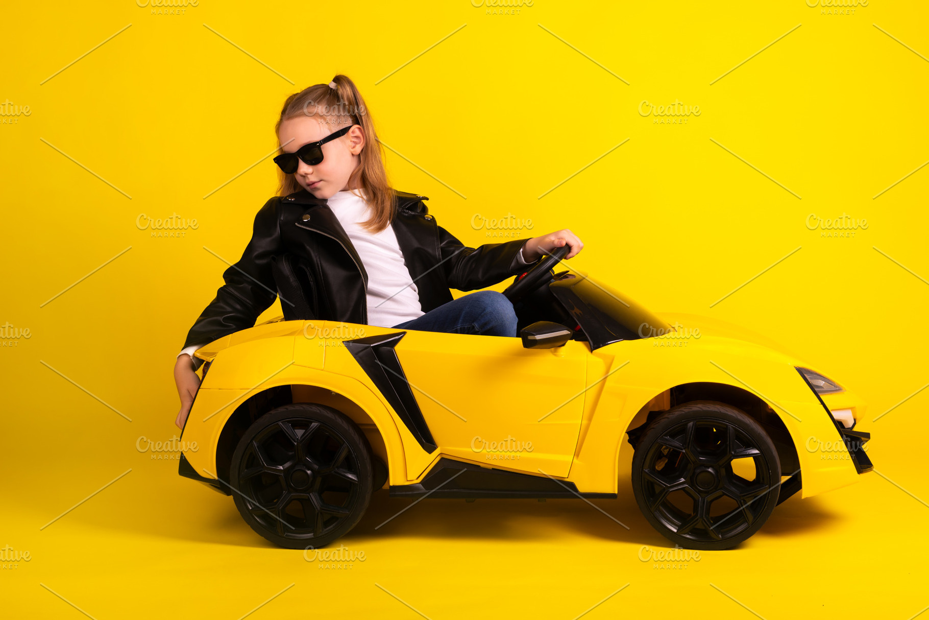 Confident young girl in sunglasses and leather jacket poses in a, a Person Photo by Ales Munt