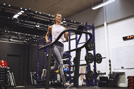 Mature woman exercising on a running machine in a gym, a Sports & Recreation Photo by Stefan & Janni