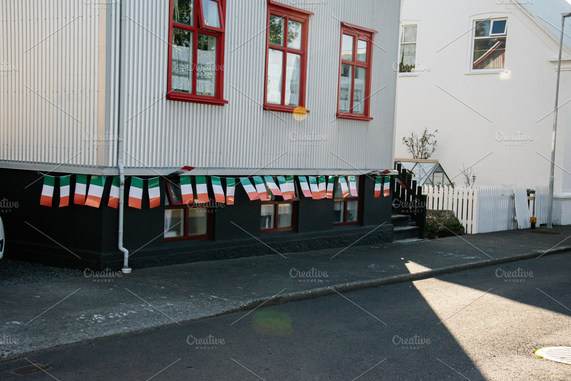 Irish flag decorations displayed outdoors on a house in Akranes, Iceland, a Photo by AS photostudio