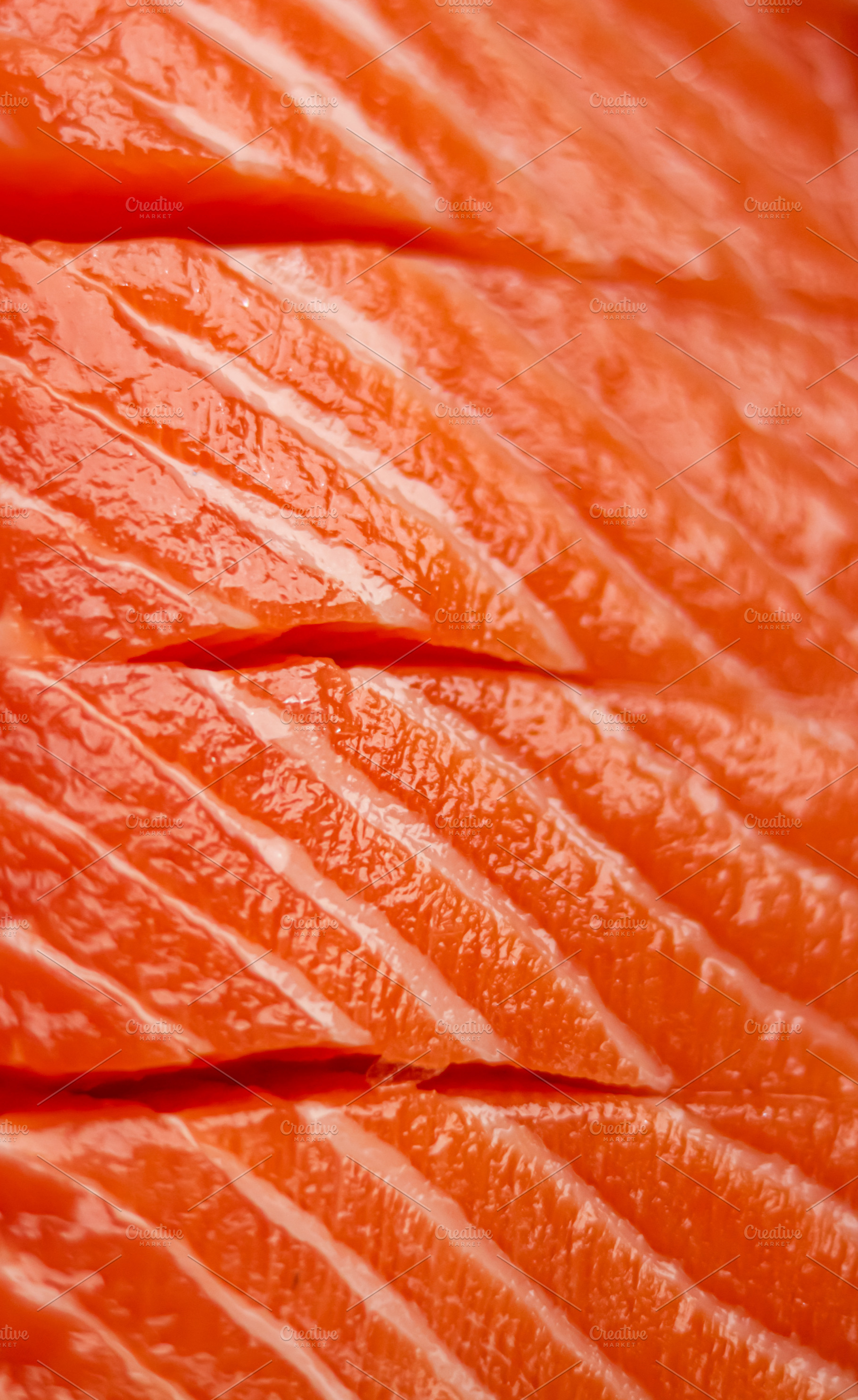 Fresh raw salmon fillets showing vibrant orange flesh texture and healthy seafo, a Photo by Studio ANNA