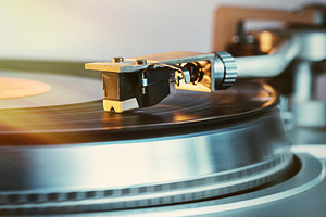 Analog turntable playing record.