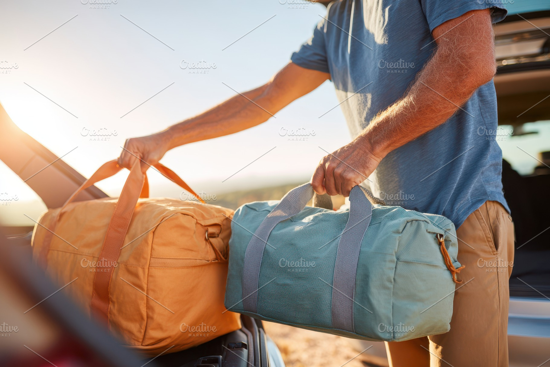 Man loading travel bags into car at sunset, a Holiday Photo by AlyaAnd