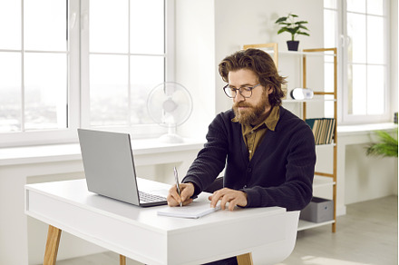 Businessman writing in a notebook, a Business Photo by StudioRomantic