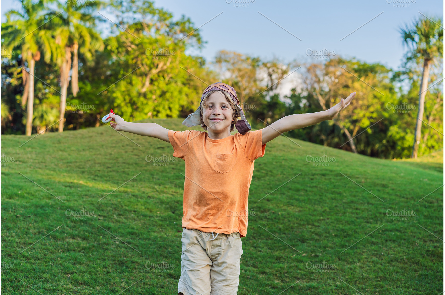 Boy wearing a pilot hat running, a Nature Photo by Elizaveta Galitskaya