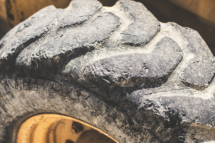 Old bulldozer tire, an Industrial Photo by Kowostock