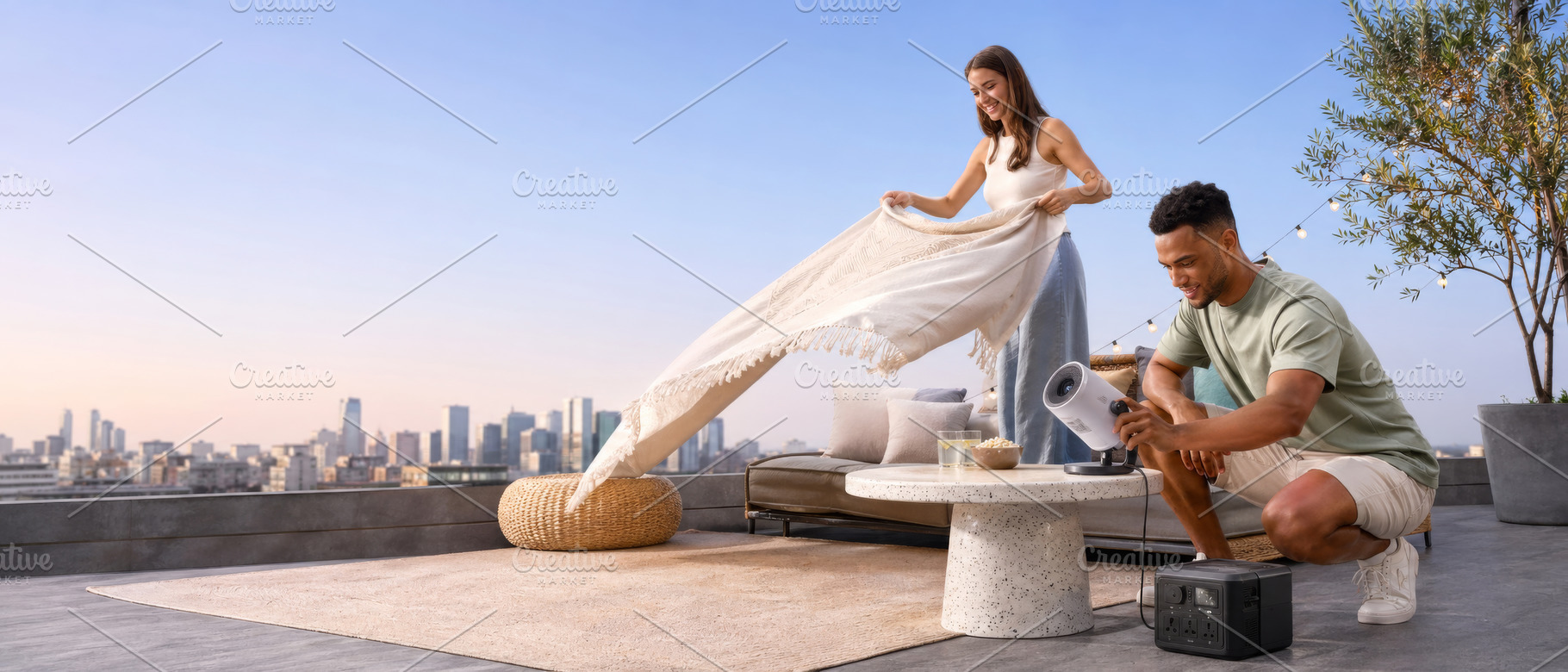 Couple preparing rooftop picnic with, a Photo by Dvoevnore photos