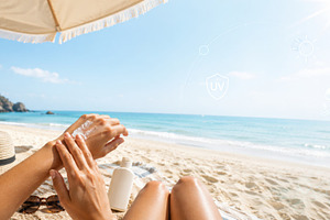 Beach scene with hands applying suns, a Photo by Dvoevnore photos
