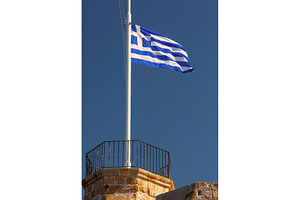 Greek flag flying over historic
