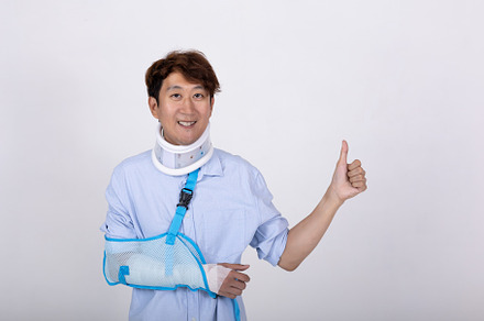 Asian man with broken arm and neck feeling showing thumbs up ges