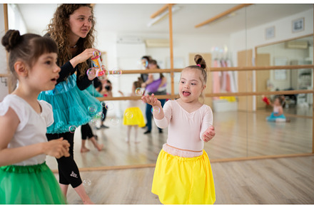 Little girls with down syndrome and, a School & Education Photo by HalfPoint