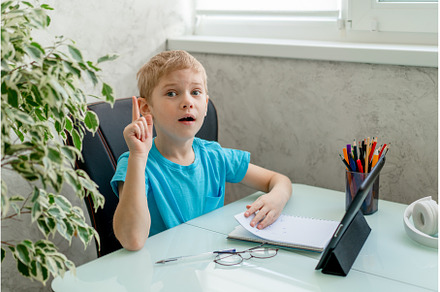 Young boy learn by tablet at home, a School & Education Photo by Ksenia Neyman