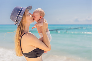 Mother holding her newborn baby by, a Person Photo by Elizaveta Galitskaya