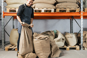 Warehouse worker folding a bag with