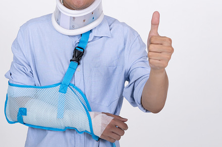 Asian man with broken arm and neck feeling showing thumbs up ges