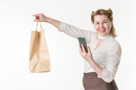 Cheerful female shopper holds paper, a Person Photo by Alexander-Piragis