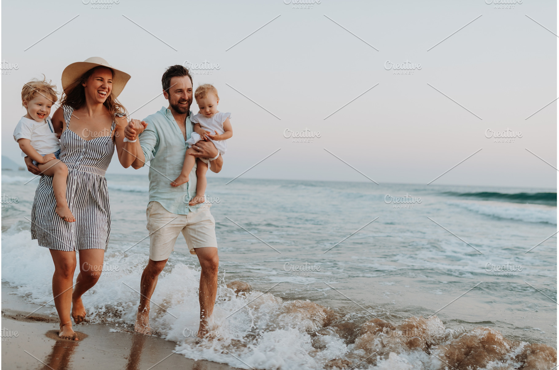 Young family walking on sandy shore, a Person Photo by HalfPoint