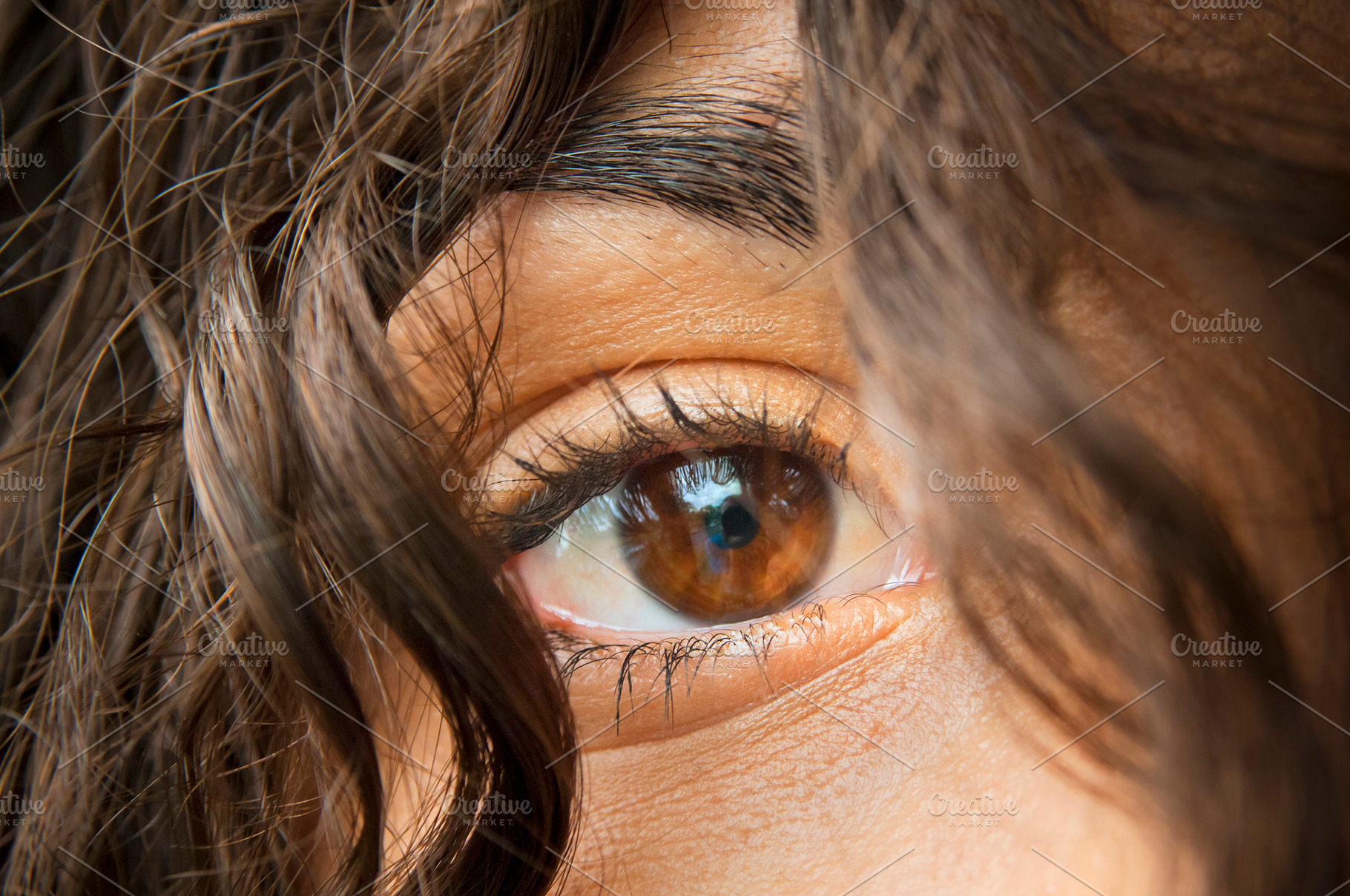 Woman's Eye Through Brown Hair, a Person Photo by THP Creative