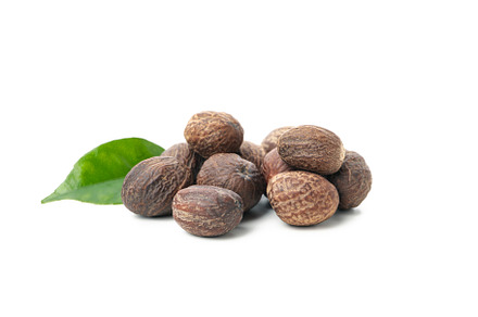 Nutmegs and leaf isolated on white background, a Food & Drink Photo by AtlasStudio