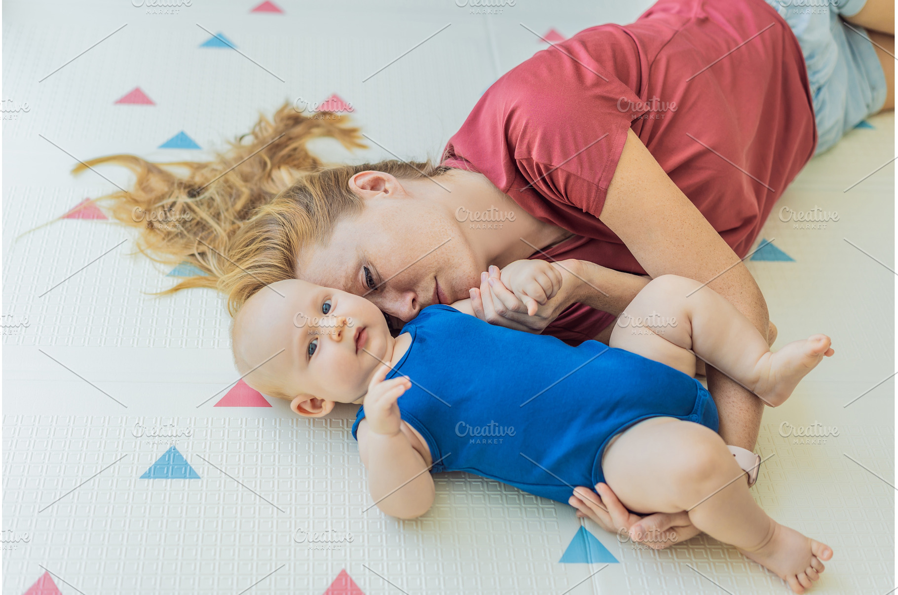 Mother and baby lying on a soft play, a Person Photo by Elizaveta Galitskaya