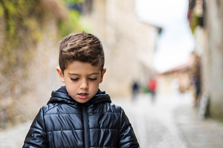 Little kid looking a map in the city, a Person Photo by Cosca