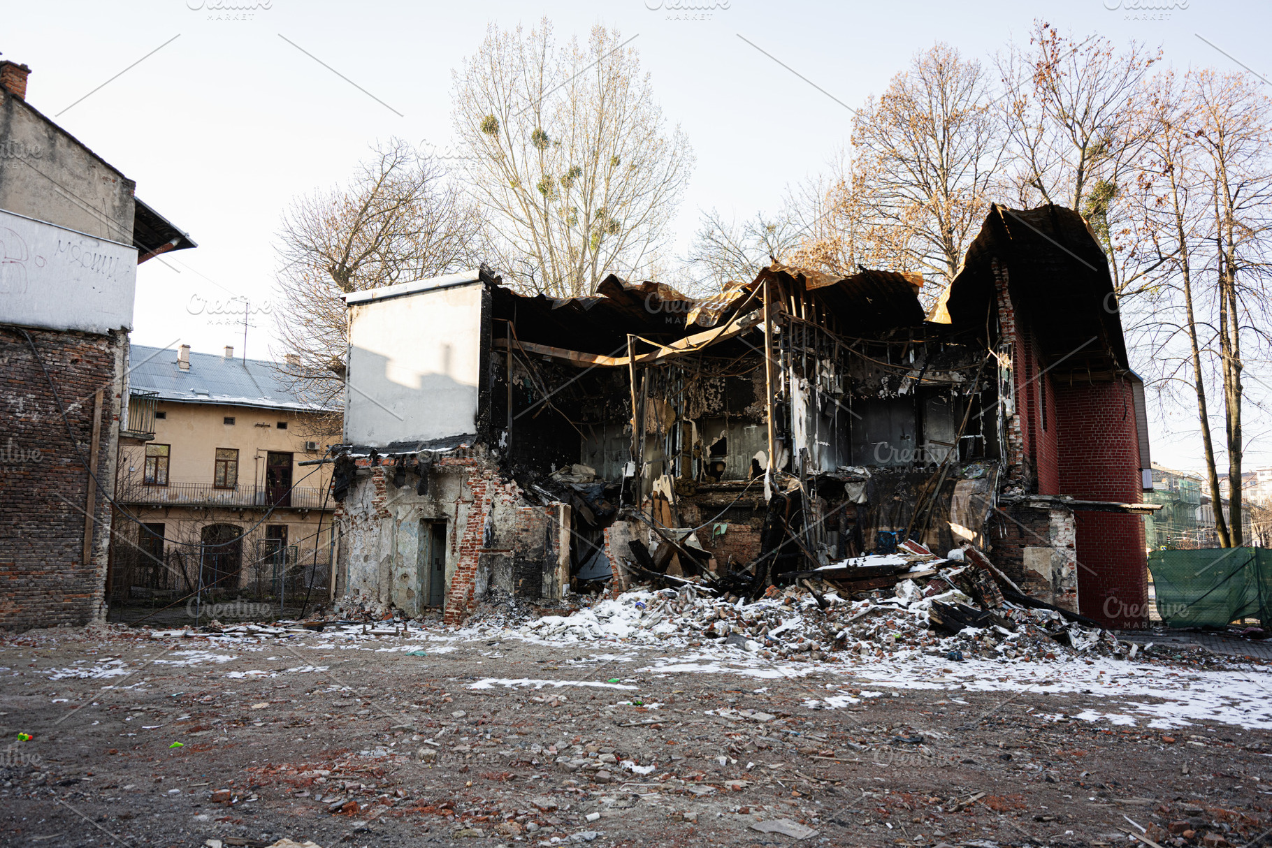 Dilapidated building in Lviv during winter showcasing urban decay and destructi, a Photo by AS photostudio