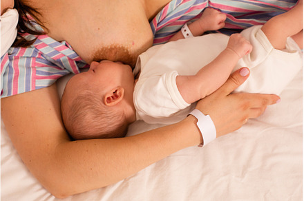 The mom is breastfeeding her newborn, a Health & Medical Photo by oksix