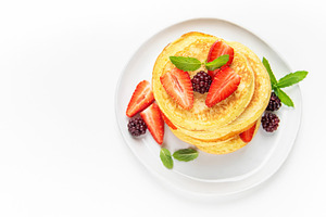 Pancakes stack with fresh berries and mint leaves, a Food & Drink Photo by Olena Rudo