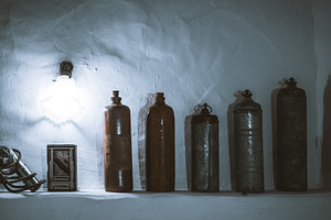 Vintage canisters under moody light, a Photo by SkyNext