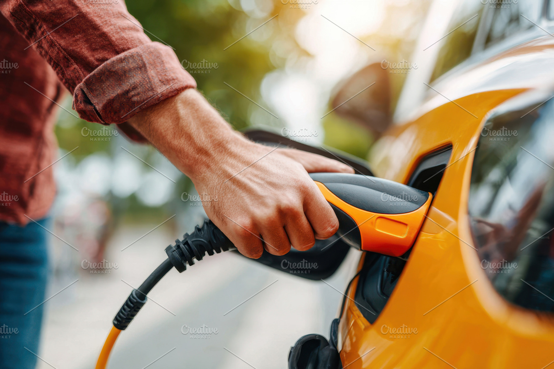 Charging an electric vehicle with a cable, a Technology Photo by AlyaAnd