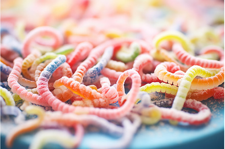 sugar-coated gummy worms close-up, a Background Photo by Sergey Kotenev
