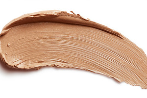 Brown foundation cosmetic product smear with creamy texture and, a Photo by Studio ANNA