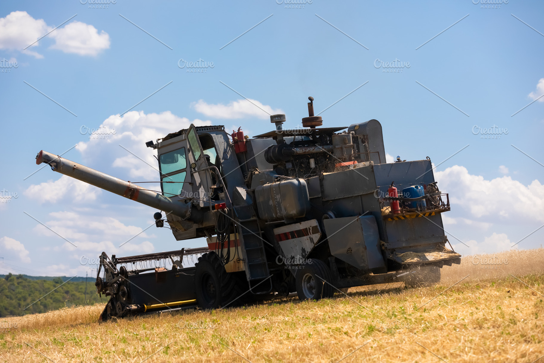 Rear-side view of an old combine harvester operating on a dry wh, a Transportation Photo by Ales Munt