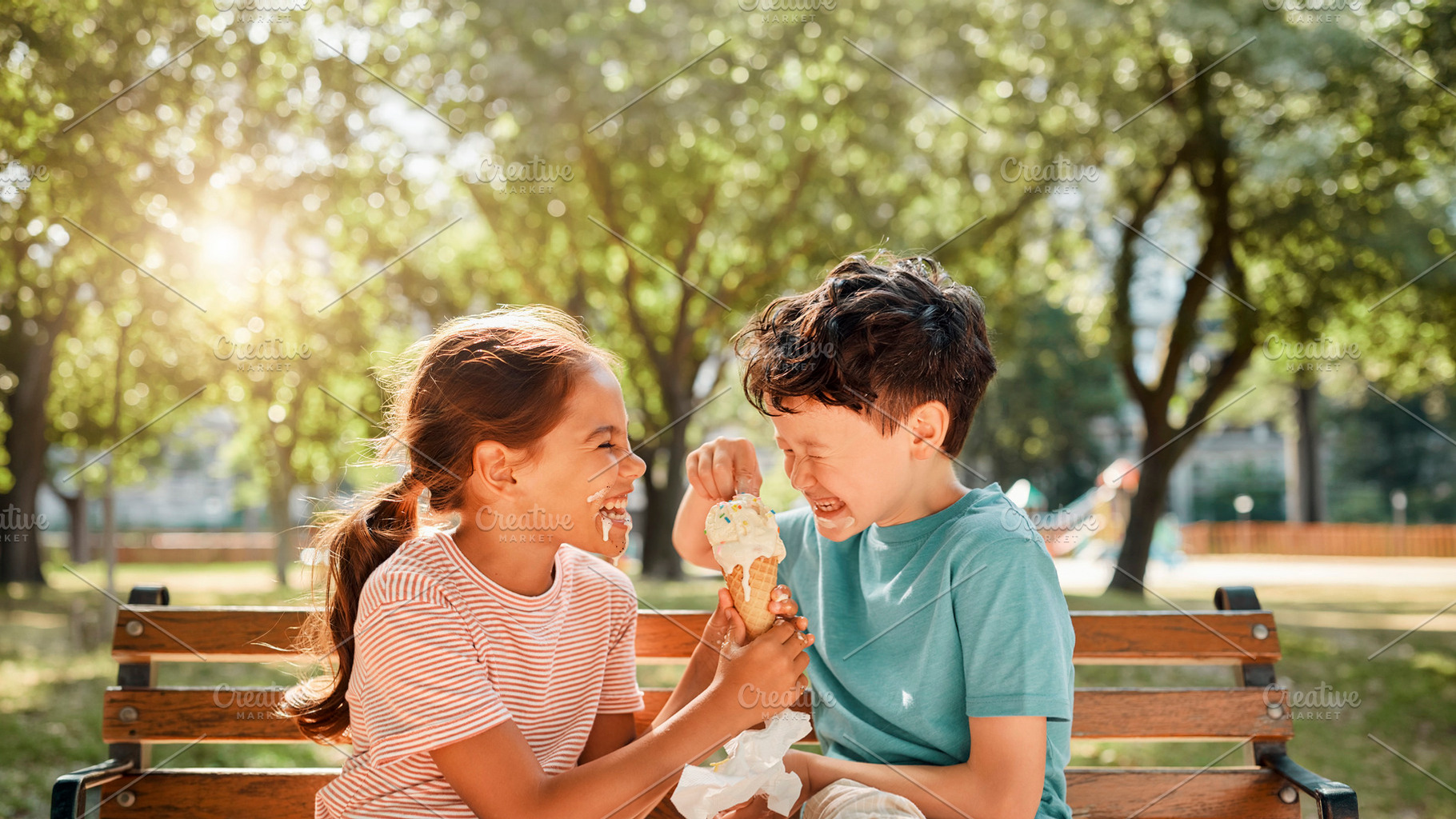 Children sharing ice cream in a park, a Person Photo by DanFLCreativo