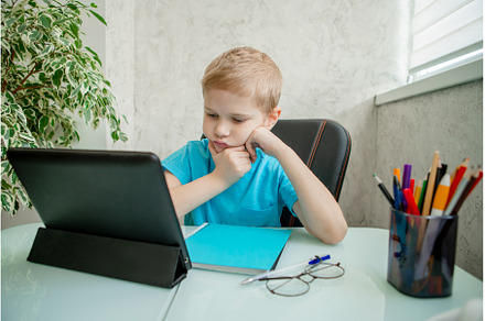 Young boy learn by tablet at home, a School & Education Photo by Ksenia Neyman