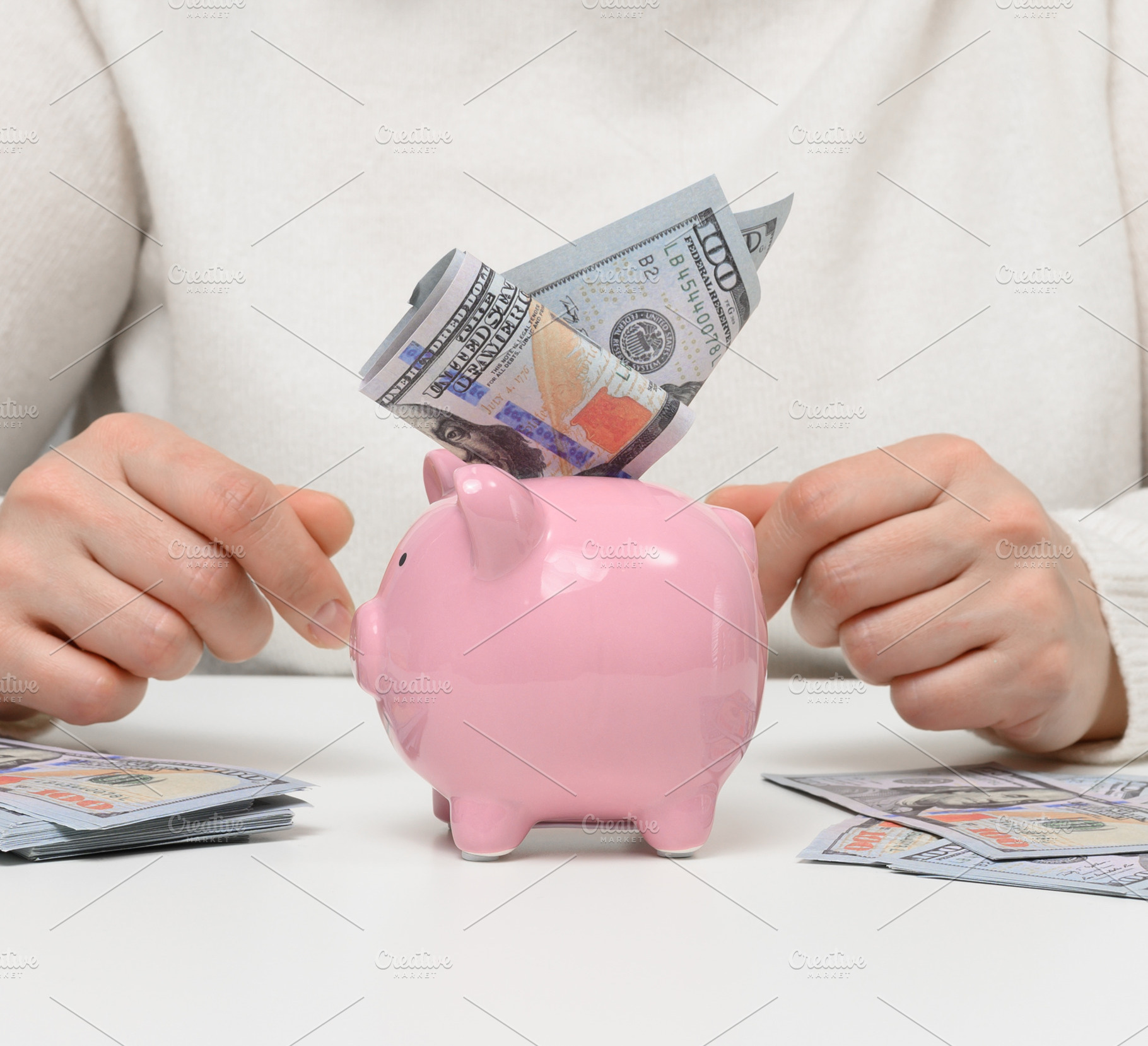 Financial savings, a pink piggy bank with a wad of hundred-dolla, a Business Photo by ndanko