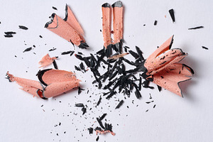 Wood shavings from black pencil on white background, top view, a School & Education Photo by ndanko