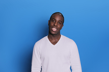 Smiling young african american man guy in casual white sweater posing isolated, a Person Photo by 2Design