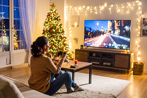 Woman relaxing in a cozy living room at christmas, a Person Photo by DanFLCreativo