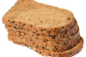Slices of whole grain bread with seeds stacked. Product on isola, a Food & Drink Photo by ndanko