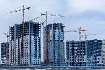 Construction site of multi-storey houses and building cranes, an Industrial Photo by Photostock